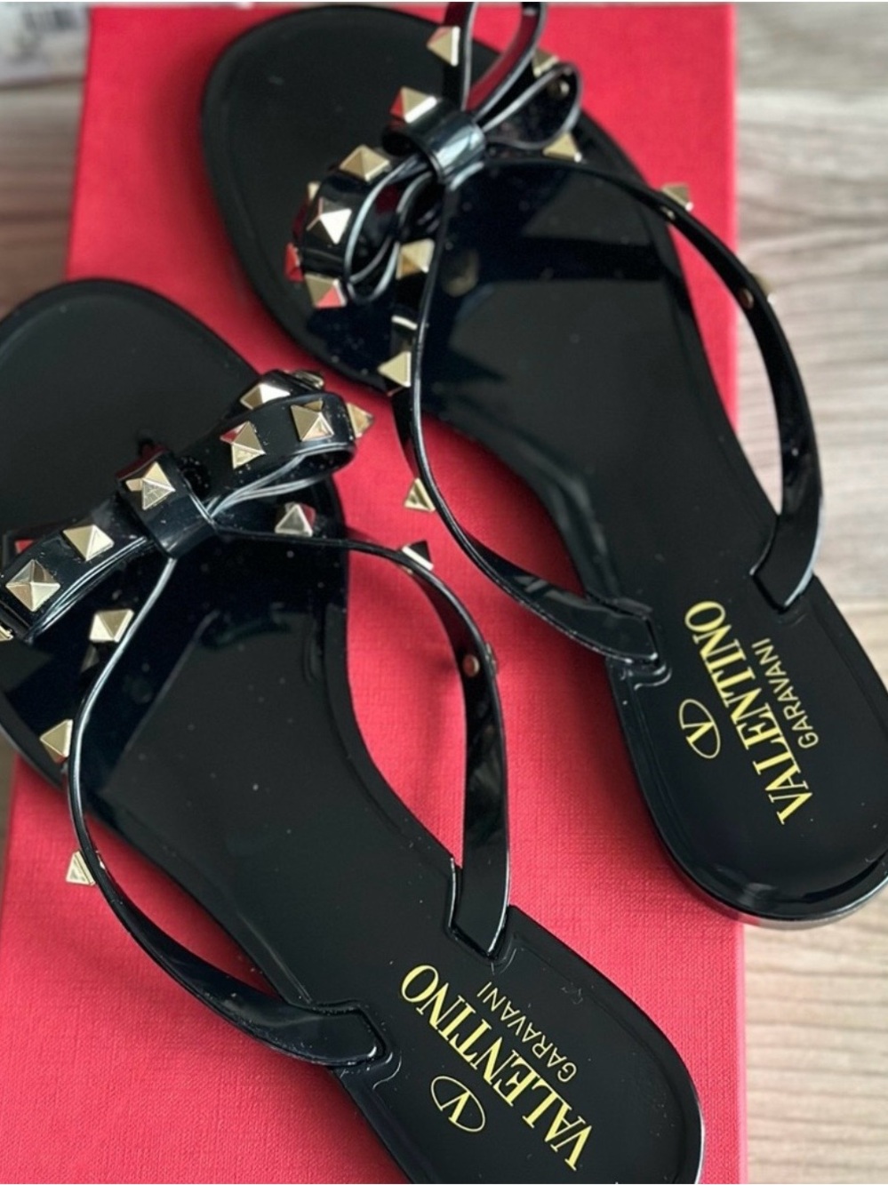 Valentino Garavani Black Jelly Bow Sandals with Gold Rockstuds